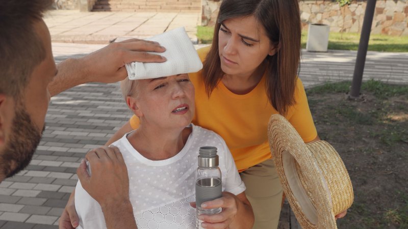 A man puts a white cloth on a woman